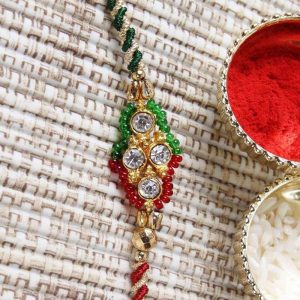 Diamond Studded Dial with Zardoshi Strings Rakhi